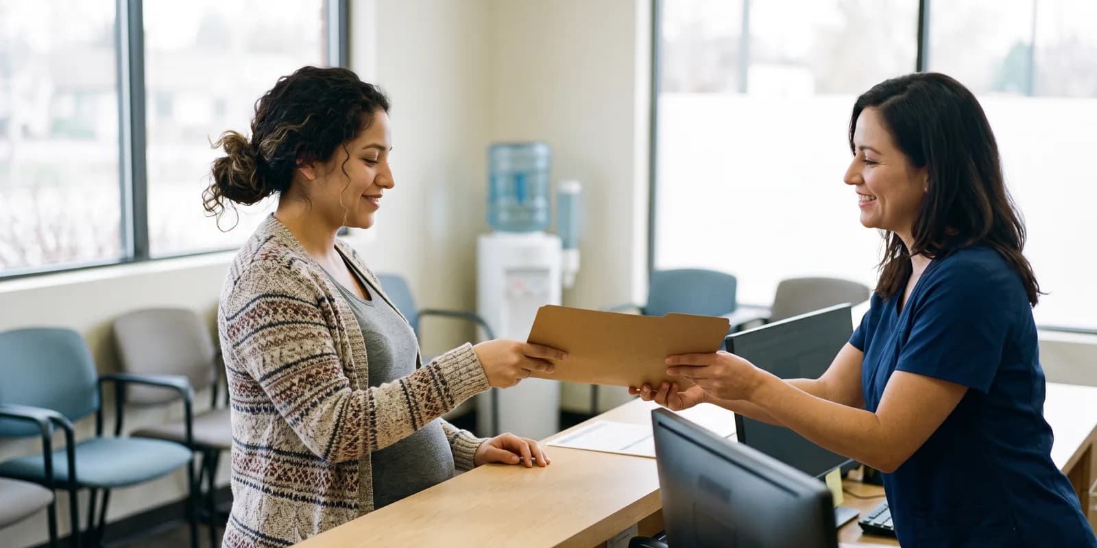 Pregnancy Medicaid and WIC do not require a home address A pregnant woman at a community health clinic front desk receiving a folder from a receptionist