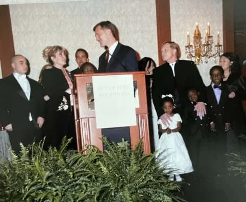 Kathy Kunkel with families at the podium during the Congressional Angels in Adoption Award ceremony