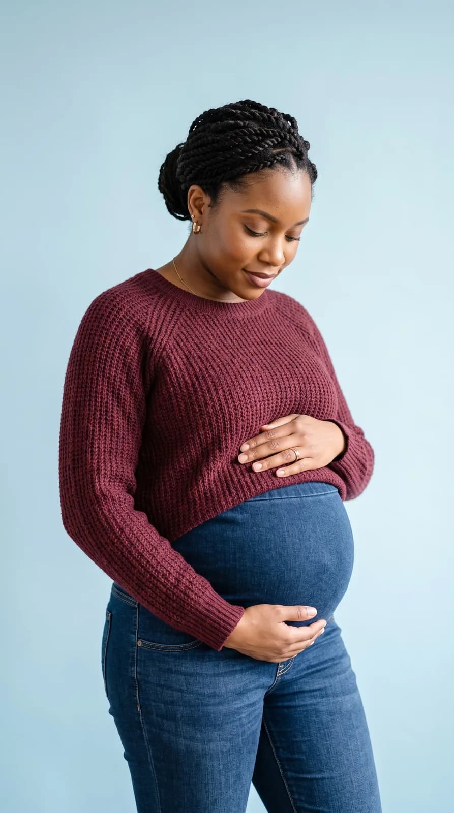Expectant mother considering giving her baby up for adoption, sitting in a calm, sunlit room