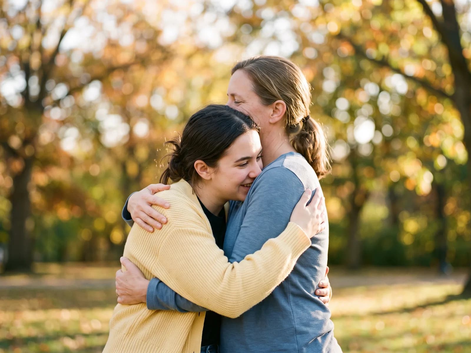 A birth mother and adoptive mother embracing — the relationship at the heart of open adoption
